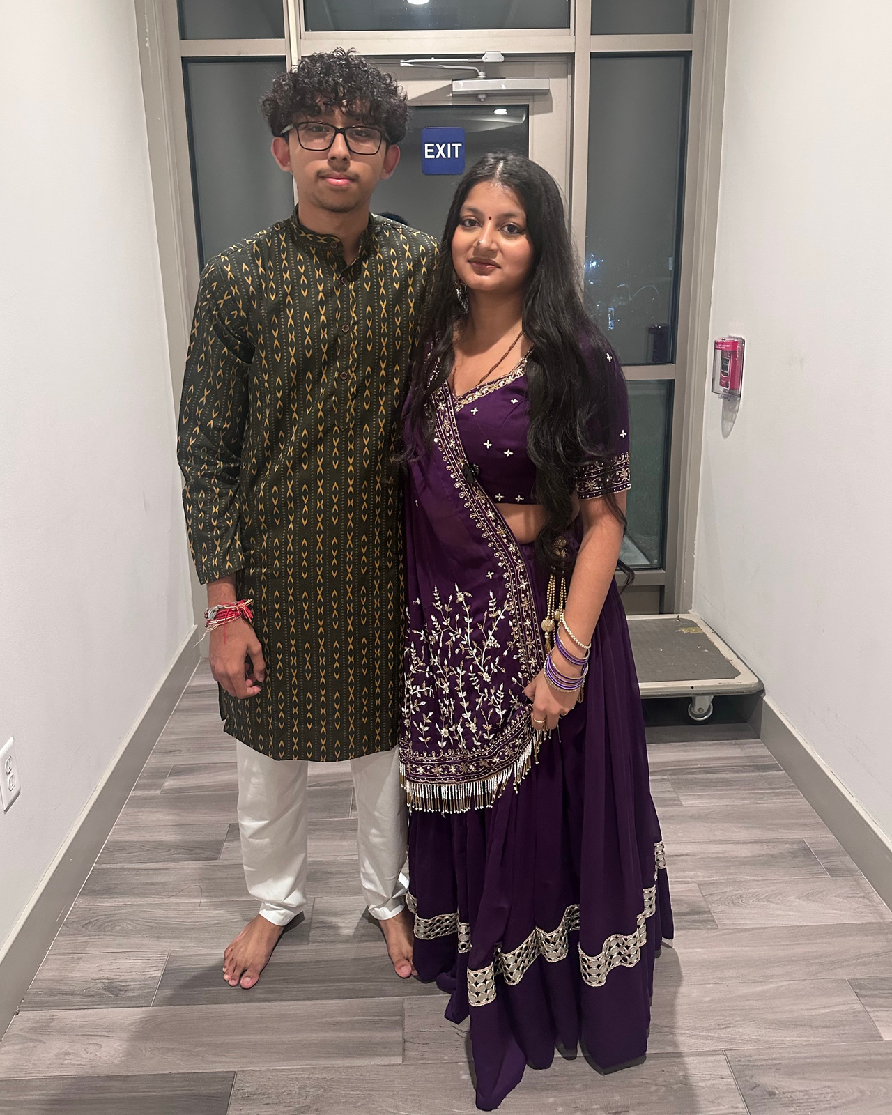 The two of us at Garba, wearing a green and gold kurta and a purple traditional outfit.
