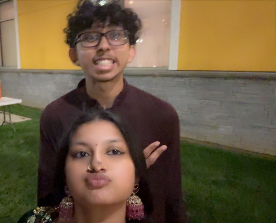 Our outdoor Garba selfie in maroon outfits, with a big grin and a playful pout.